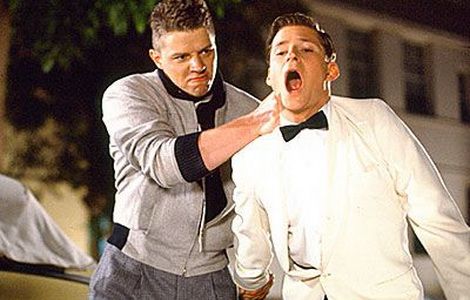 Biff and George Mcfly on a parking lot fighting 