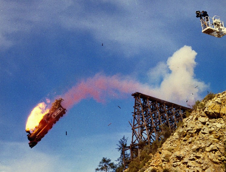 The crew films the train going off the end of the rails and into a ravine from a crane.